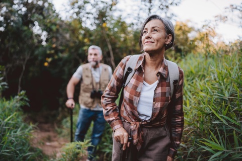 Senior couple walking on forest mountain trail while enjoying a Rwanda public holiday