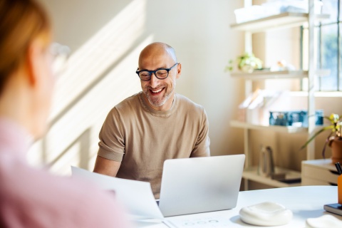 Smiling man having a business meeting about business etiquette in Sweden