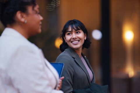 Smiling businesswoman talks with a colleague about workplace culture in Nepal