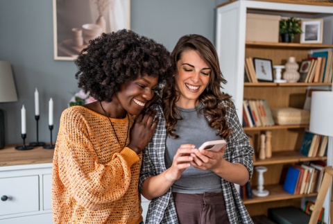 Friends in an apartment smiling at a phone during Mauritius’ public holidays