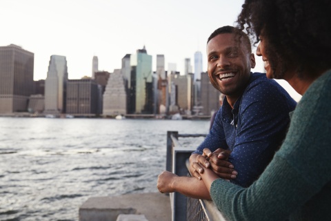 Young Indonesian couple standing on the quayside