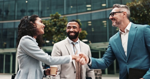 Business people shaking hands and displaying proper business etiquette in Haiti
