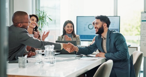 Colleagues shaking hands during a business meeting