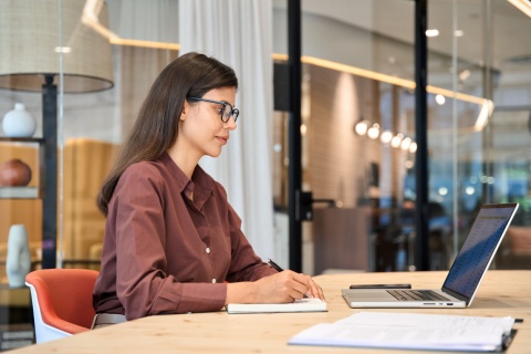 Female data entry specialist working on a laptop