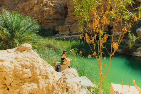 Hiker at Wadi Ash Shab enjoying Oman’s public holidays