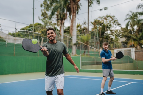 Friends playing pickleball together during Liberia’s public holidays