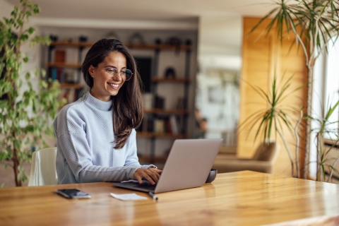 Project coordinator working on a laptop at home