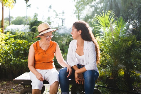 Two women sitting on a bench enjoying a Haitian public holiday